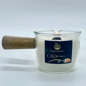 Stress Knot NYC C.B.Destress massage candle with wooden handle for soothing aromatherapy and pain relief treatments.